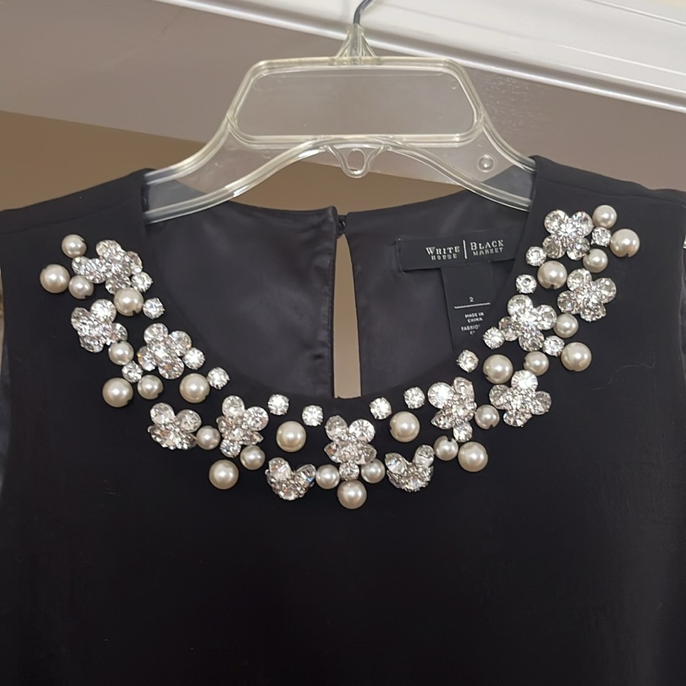 White House Black Market sleeveless crew neck line embellished dress.